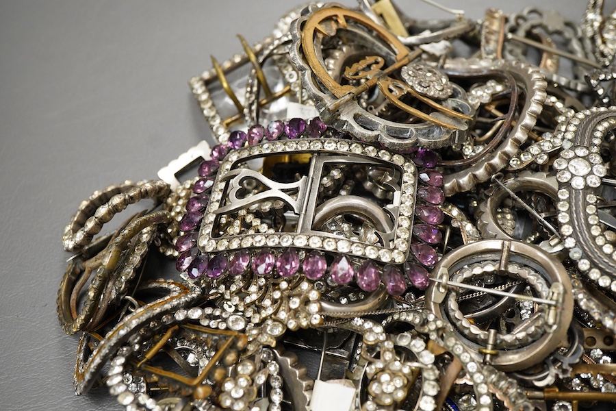 A large collection of buckles, 18th-early 20th century, of oval and rectangular outline, set with pastes, some with cut steel, mostly mounted in steel, a minority in silver, some with later brooch fittings